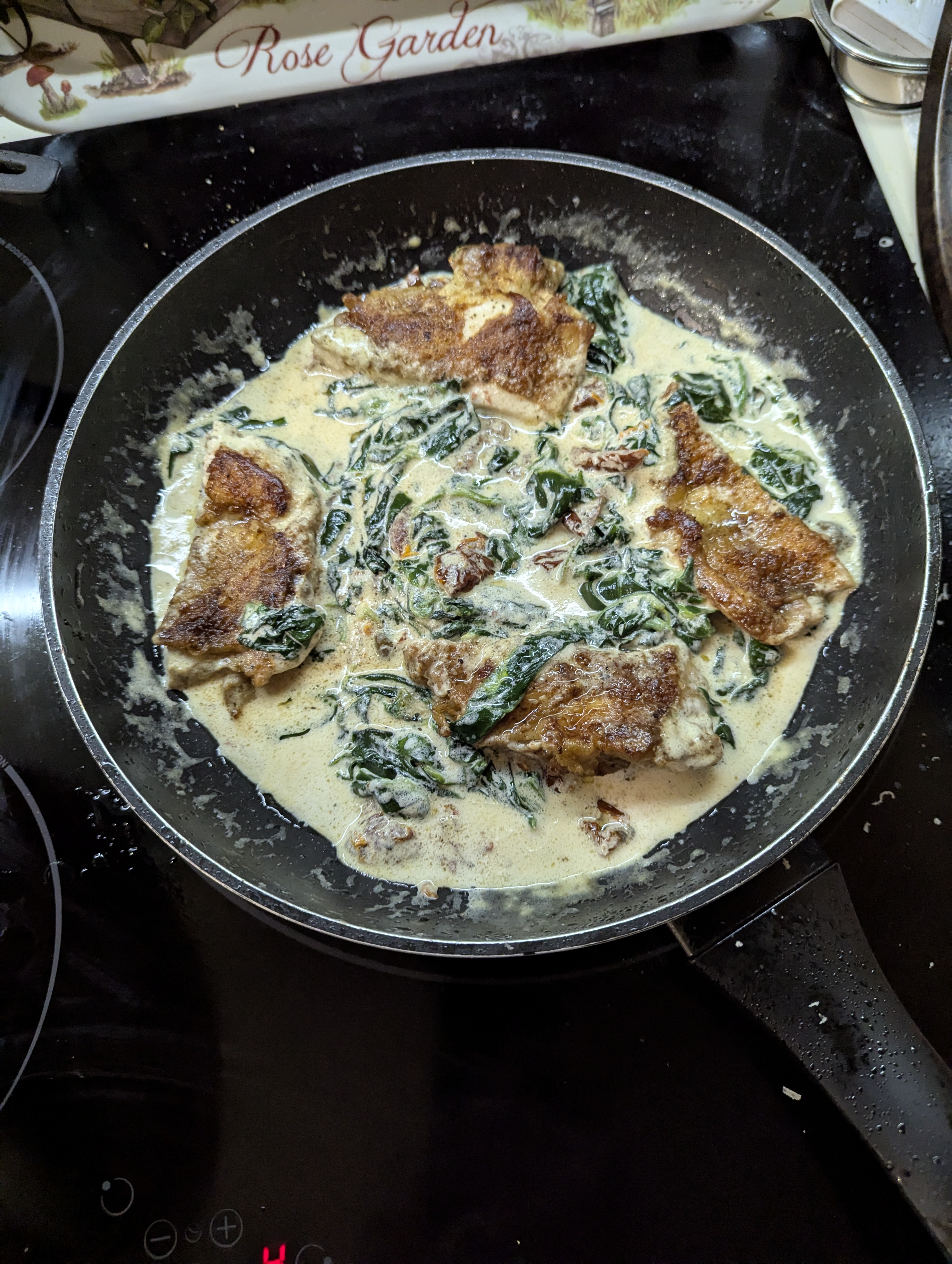 Chicken thighs and drumsticks in creamy sauce of spinach and parmesan